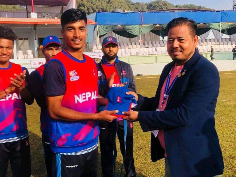 Rashid Khan receives a debut T20 Cap from CAN treasurer Roshan Singh before the match against Bhutan during SAG 2019.