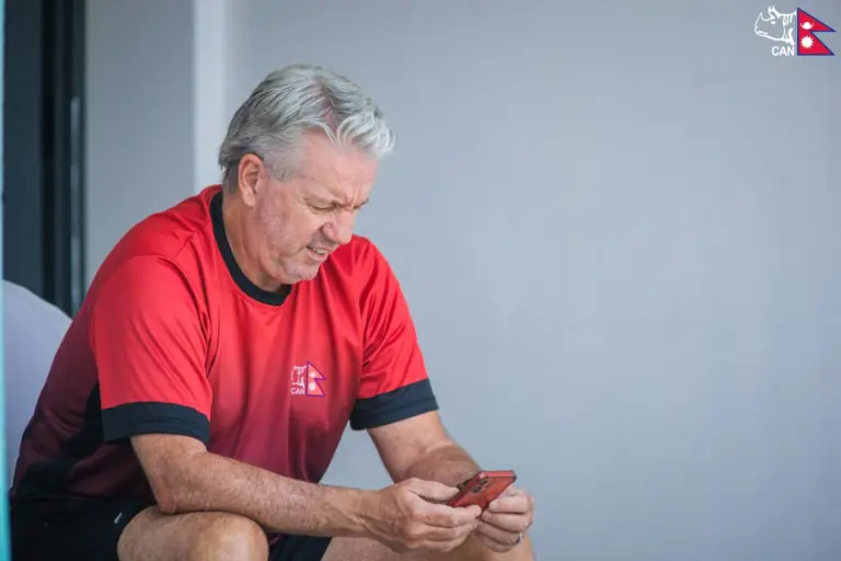 Stuart Law looks at his mobile phone